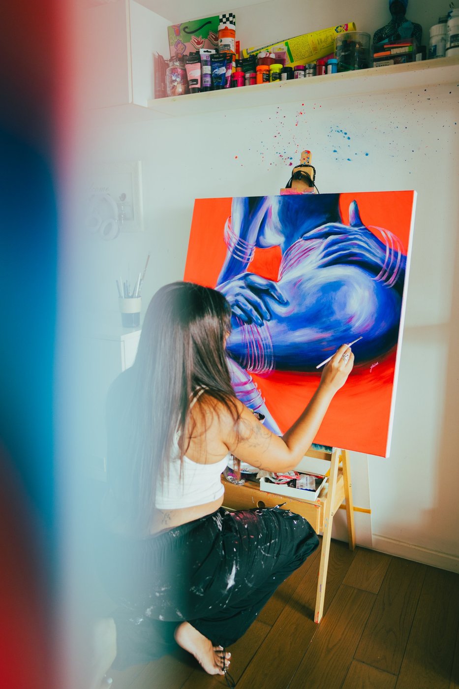 Irina Rezwan painting one of the Shameless series pieces at her easel
